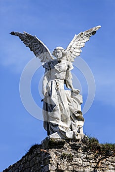 Sculpture of a Guardian angel with a sword in the cemetery of Comillas photo