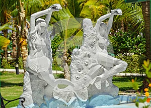 Sculpture of half-naked sea siren and mermaid