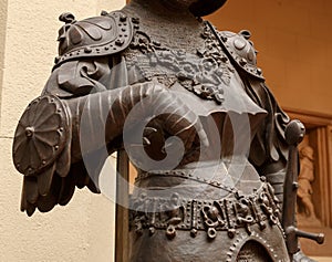 Sculpture of King Arthur old metal statue. Medieval knights armor full size standing warrior. Order of the Knights