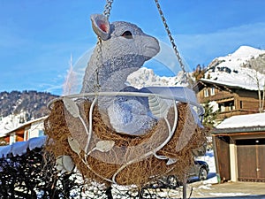 A sculpture of a little deer in a hammock with hay and in the shape of a nest, Wildhaus - Canton of St. Gallen, Unterwasser