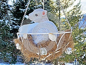 A sculpture of a little deer in a hammock with hay and in the shape of a nest, Wildhaus - Canton of St. Gallen, Unterwasser