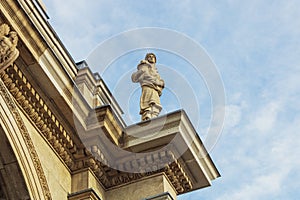 The sculpture of a man holding a cornucopia at the top of The Princes' Gates entrance in Toronto