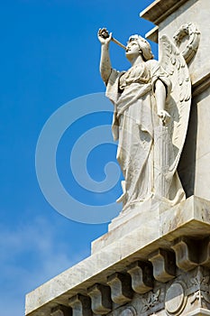 Sculpture of a marble angel playing the flute