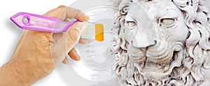 Sculpture of a medieval lion head of stone Italy - concept image with hand and brush