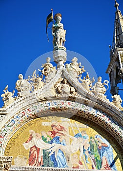 Sculpture and mosaic painting of St. Mark`s basilica, in Venice, Italy