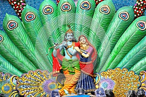 Sculpture of Radha Krishna and peacock feather during Dahi Handi festival