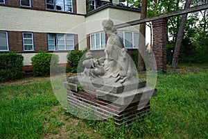 Sculpture of a resting mother. Mittelheide, 12555 Berlin, Germany