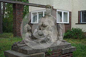 Sculpture of a resting mother. Mittelheide, 12555 Berlin, Germany