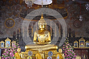 A sculpture of a seated Buddha in the temple of Wat Rakhang Khositaram Ubosot. Bangkok, Thailand