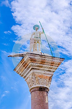 The sculpture of St. Theodore on the top of the west tower, Piazzetta San Marco, Venice, Italy....IMAGE