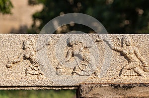 Sculpture on stone show 3 dancing women at Royal Enclosure, Hampi, Karnataka, India