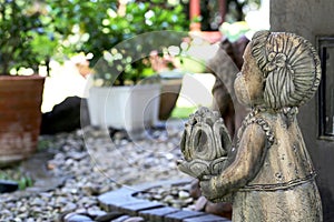 Sculpture Thai girl doll in the pebble garden