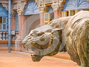 Sculpture of a tiger or a lion neer Mysore Palace. An animal with open mouth with canine teeth.