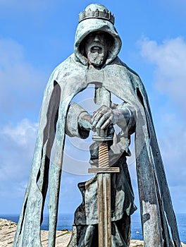 A sculpture at Tintagel Castle in Cornwall, England, from the mainland.