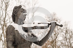 Sculpture with violinist in winter day, Kuldiga, Latvia