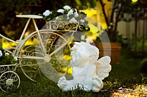 Sculpture of white angel in garden.