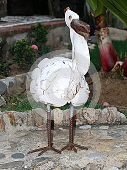Sculpture of a white swan hanging out by the swimming pool, photo