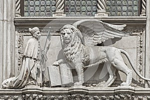 Sculpture of winged lion of Venice with priest and book, Venice