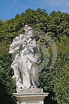 Sculpture of a woman playing the flute in the garden of Belvedere palace in, Vienna