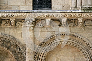 Sculptured animals and fantastic characters decorate the facade of a church (France)