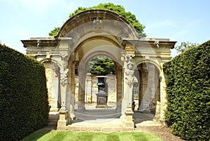 Sculptured archway & urn on a plinth at the Italian garden of Hever castle in England