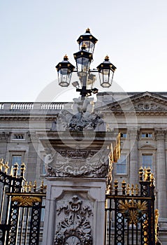 Sculptured gate post with a vintage lamp of Buckingham Palace in London, England, Europe