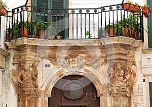 Sculptures and balcony in Martina Franca, Italy photo