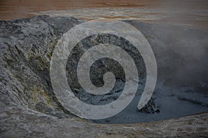 Sculptures of boiling grey mud in Hverir, Krafla geothermal area, Iceland in summer, closeup