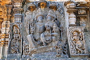 Sculptures on the facade, west side walls. Shiva-Parvati. Hoysaleshwara temple, Halebidu, Karnataka. view from West.