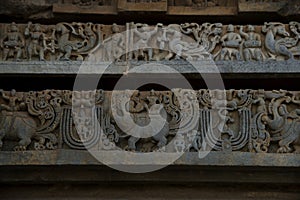 Sculptures and Friezes on the outer walls of Hoysaleswara Temple at Halebidu , Karnataka, India