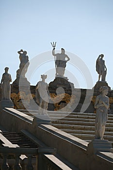 Sculptures of the Golden Mountain Cascade fountain on a sunny day in backlight. Lower Park, Peterhof