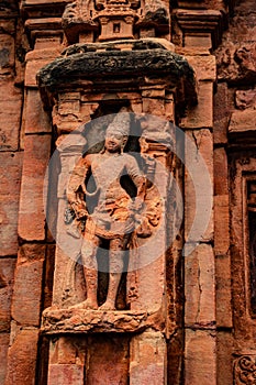 Sculptures of hindu gods on facade of 7th century temple carved walls in Pattadakal