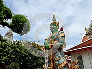 The sculptures of mythical giant demons, Thotsakan, guarding the eastern gate of the main chapel of Wat Arun Ratchawararam