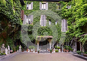 Sculptures, plants and Ivy on the outside of the Atellani House, Museo Vigna di Leonardo, Milan.