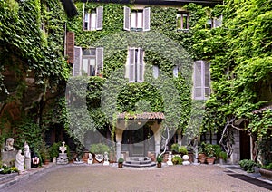 Sculptures, plants and Ivy on the outside of the Atellani House, Museo Vigna di Leonardo, Milan. photo