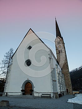 Scuol church in winter time evening