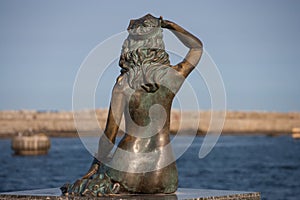 Scuplture of a siren with the sea view