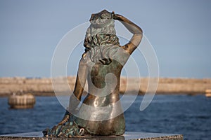 Scuplture of a siren with the sea view photo