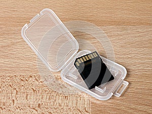 SDHC memory card in plastic container on desk