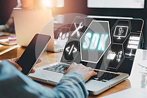 SDK - Software development kit programming language technology concept, Person typing keyboard computer with SDK icon on virtual