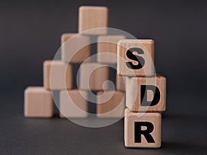 SDR - acronym on wooden cubes on a dark background