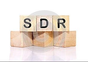 SDR text on wooden cubes on a white background