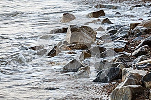 The sea accumulates on the coastal rocks.