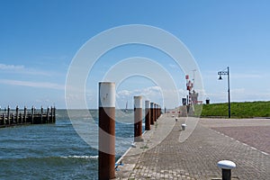 By the sea along the pier with a light house