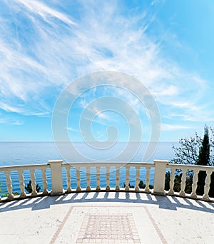 Sea and balcony under cloudy sky