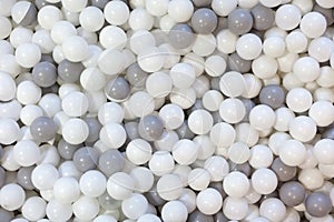 sea of balls pattern-white and grey plastic toys. Top view ball pool at indoors playground for kids