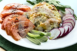 Sea bass, covered with mashed potatoes with fresh vegetables