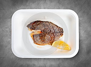 Sea bass fillet. Healthly food. Takeaway food. Top view, on a gray background