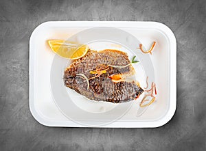 Sea bass fillet. Healthly food. Takeaway food. Top view, on a gray background