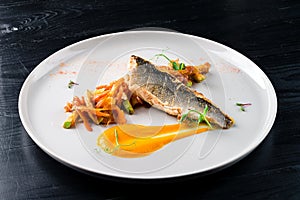 Sea bass with vegetables stir fry, seared sea bass served with stir fried baby vegetables, healthy lunch or dinner